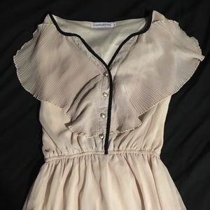 Cream colored with black trim ruffle top dress